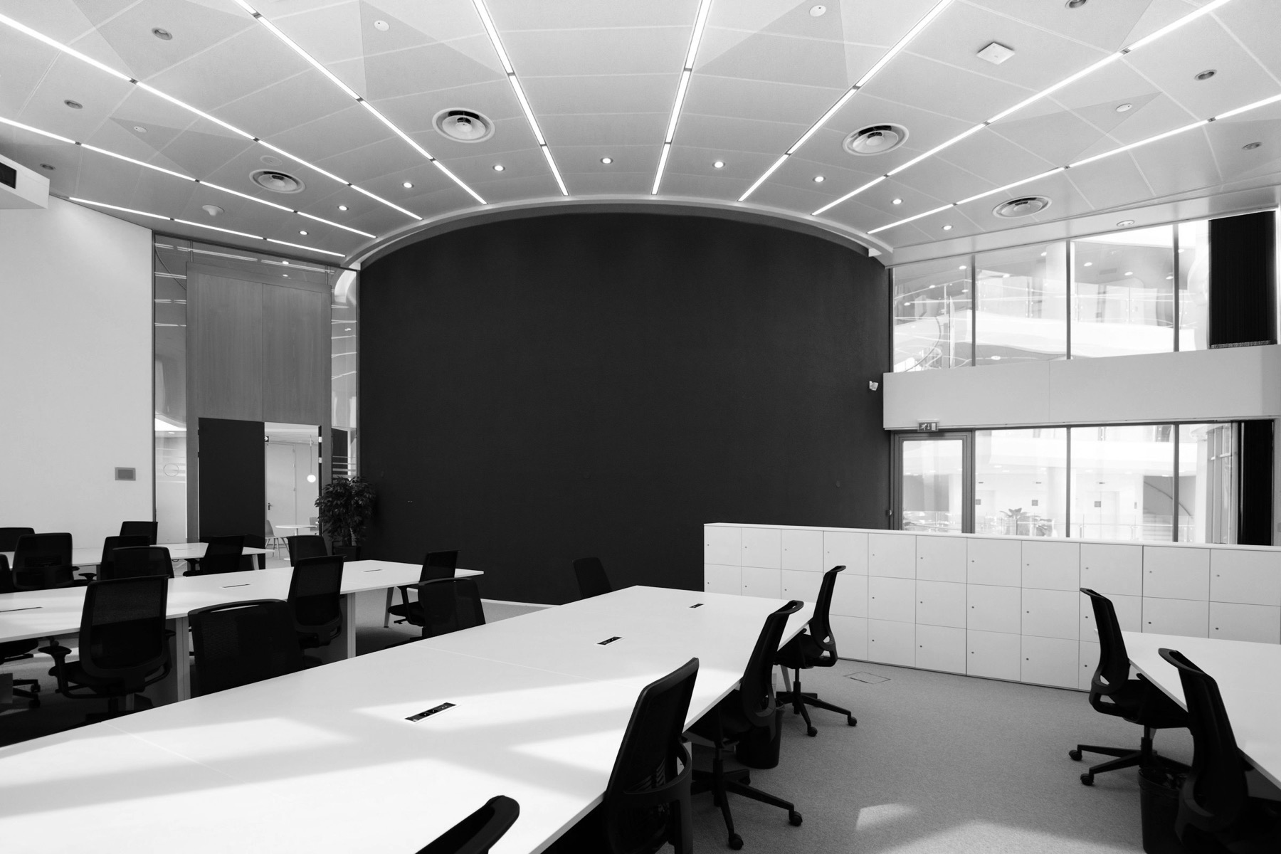 An empty modern boardroom with floor-to-ceiling glass
