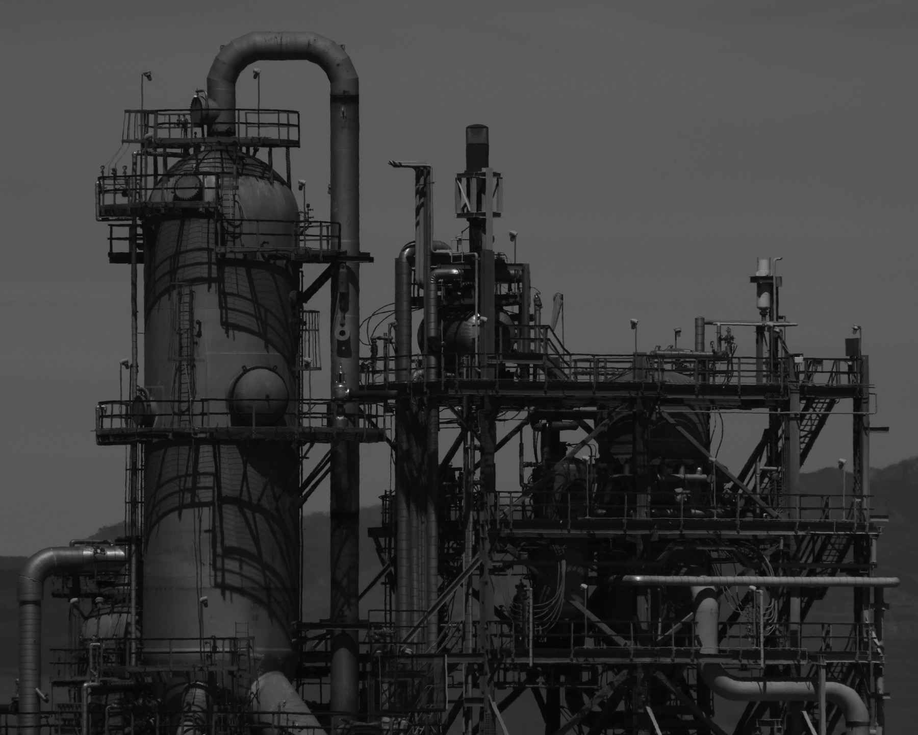 A black and white industrial plant exterior