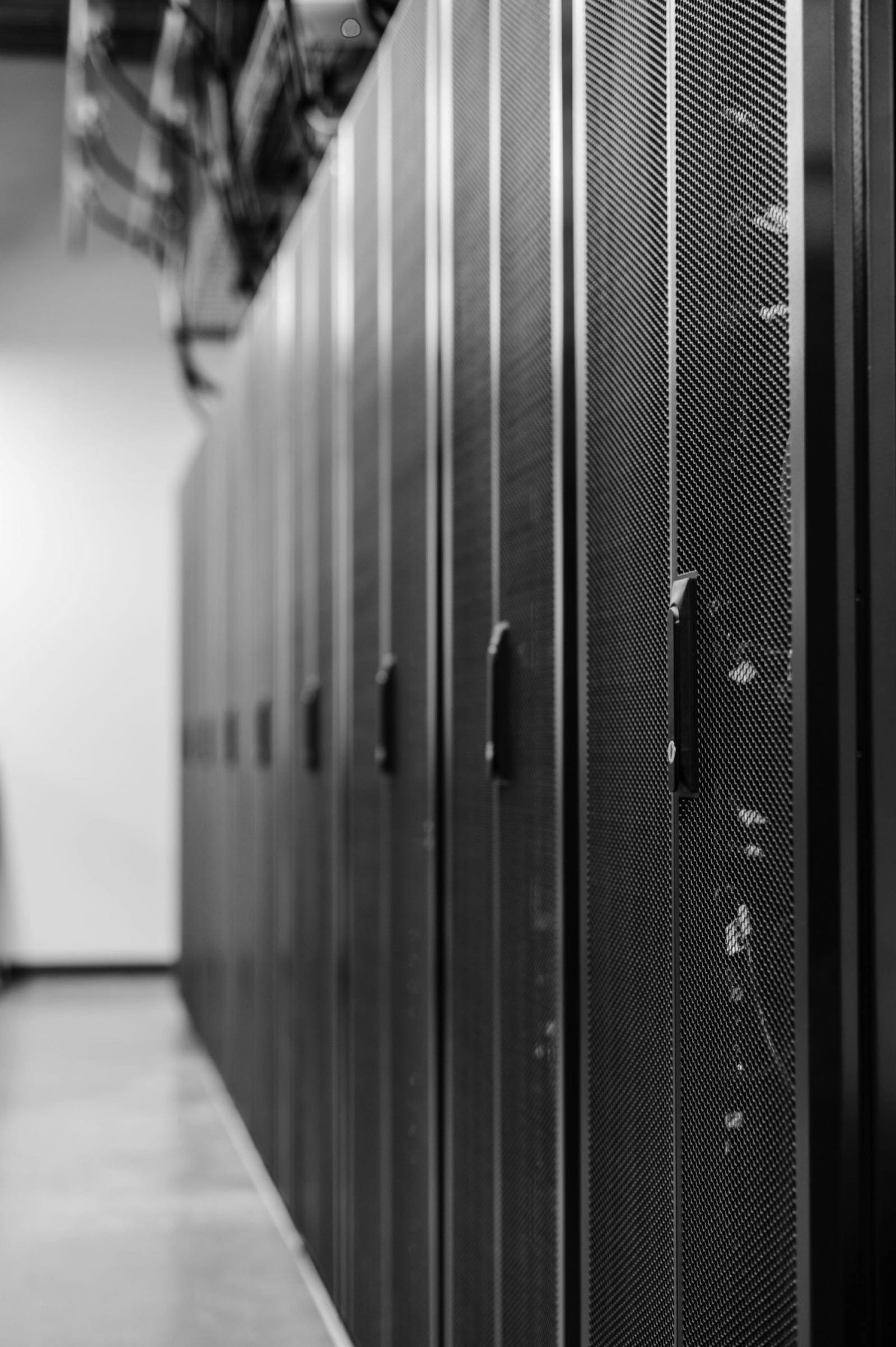 Server racks along a tall corridor